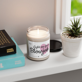 a candle sitting on top of a table next to a book