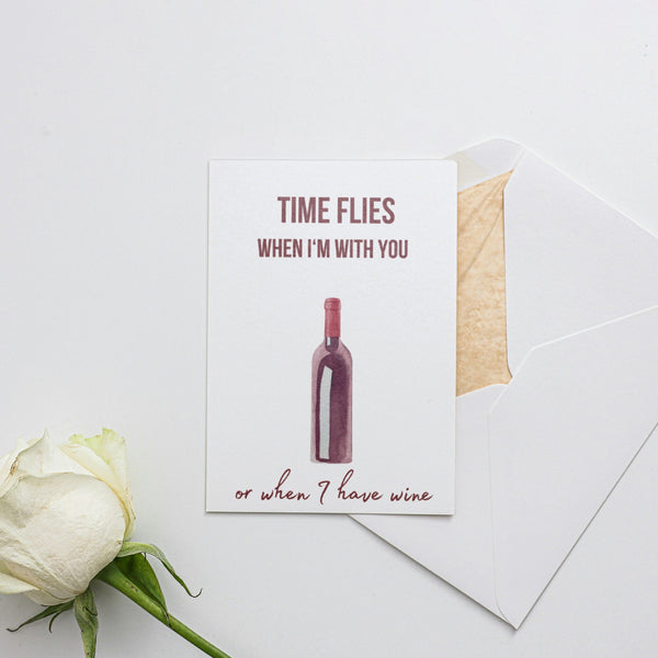 a card with a wine bottle and a rose