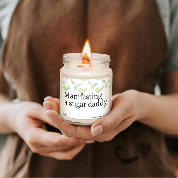 a woman holding a jar with a candle in it