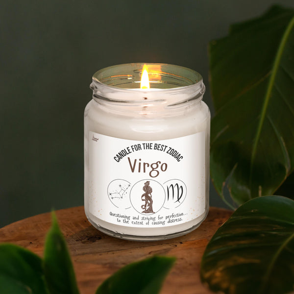 a white candle sitting on top of a wooden table