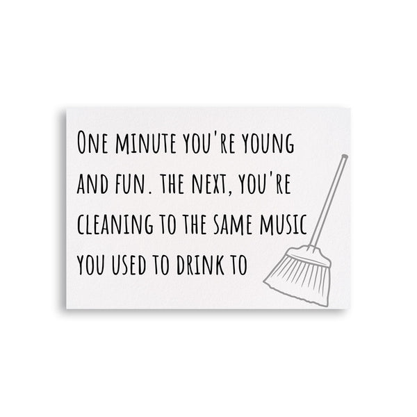 a card with a black and white image of a broom