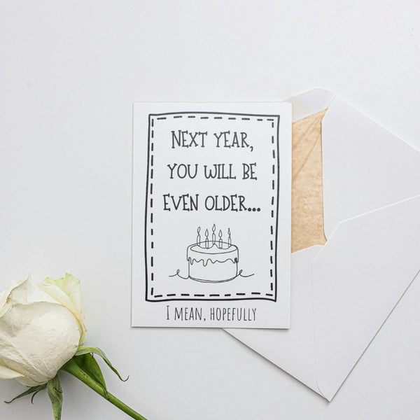 a card with a birthday cake and a flower