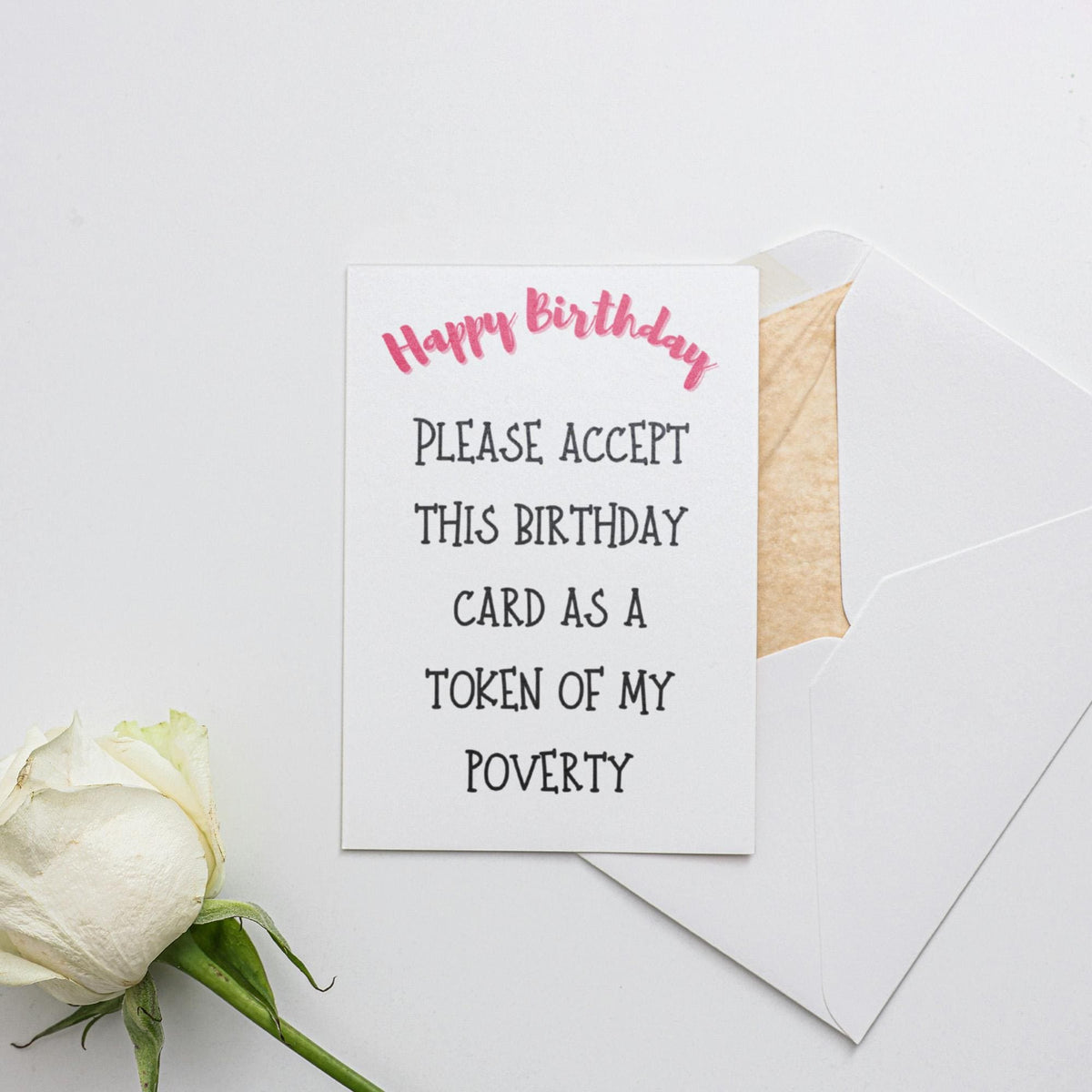 a birthday card with a white rose and a piece of paper