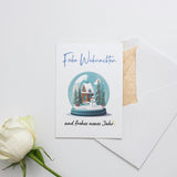 a card with a snow globe and a white rose